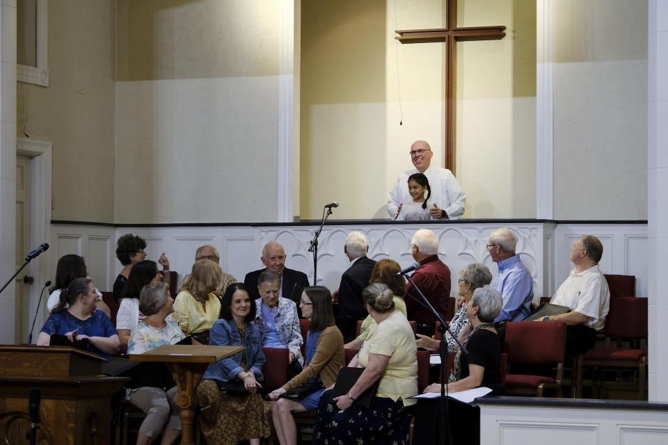 Members of the First Baptist Church of Farmersville choir watch Pastor Bart Barber baptize Aubree Rodriguez in Farmersville, Texas, on Sunday, Sept. 25, 2022. Delegates of the Southern Baptist Convention elected Barber as president on June 14, 2022. (AP Photo/Audrey Jackson)