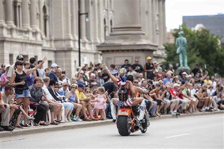 Spectators line the street as Harley riders participate during the the Harley Davidson 110th Anniversary Celebration parade in Wisconsin Avenue, Milwaukee August 31, 2013. REUTERS/Sara Stathas