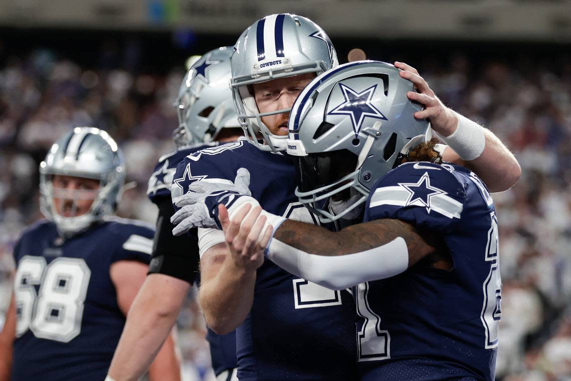 Dallas Cowboys running back Ezekiel Elliott (21) celebrates with Dallas Cowboys quarterback Cooper Rush (10) after scoring a touchdown against the New York Giants during the third quarter of an NFL football game, Monday, Sept. 26, 2022, in East Rutherford, N.J. (AP Photo/Adam Hunger)