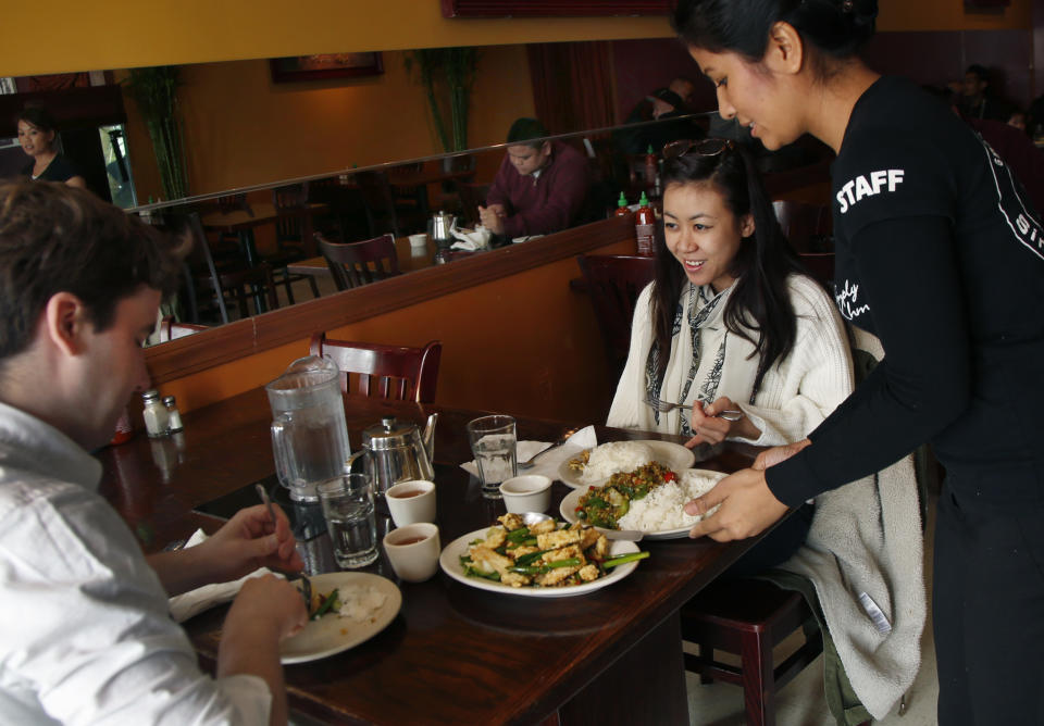 This March 14, 2014 photo shows diners at Simply Khmer, a Cambodian restaurant in Lowell, Mass. Simply Khmer is considered by some to offer the best _ and most authentic _ Cambodian food in Lowell. (AP Photo/Elise Amendola)