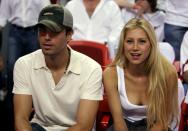 FILE PHOTO: Singer Enrique Iglesias (L) and tennis star Anna Kournikova of Russia watching the NBA Finals