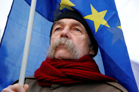 A man holds an EU flag as he takes part in a protest against a proposed new labor law, billed as the "slave law", in Budapest, Hungary, January 19, 2019. REUTERS/Bernadett Szabo