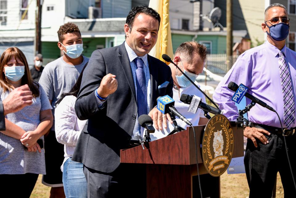 A fire destroyed the Paterson armory in 2015. Paterson officials gather at the site of the armory on Thursday August 20, 2020 to break ground on a new project led by developer Charles Florio to transform the lot into 138 apartments, commercial space as well as a police substation. Paterson Mayor André Sayegh speaks. 