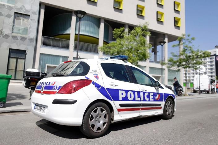 A police vehicle is parked outside the student residence where an It student -- suspected of planning an attack on churches -- lived in Paris, on April 22, 2015 (AFP Photo/Kenzo Tribouillard)