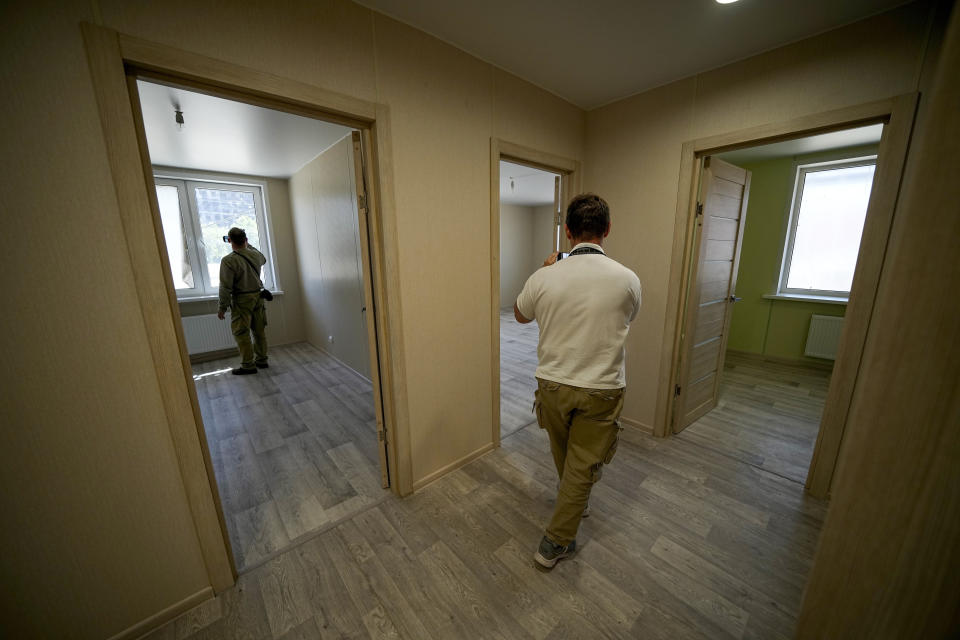 FILE - Foreign journalists look inside a new unit in a new apartment block that is being built with the support of the Russia Defense Ministry in Mariupol, in territory under control of the government of the Donetsk People's Republic, in eastern Ukraine, Wednesday, July 13, 2022. This photo was taken during a trip organized by the Russian Ministry of Defense. (AP Photo/File)