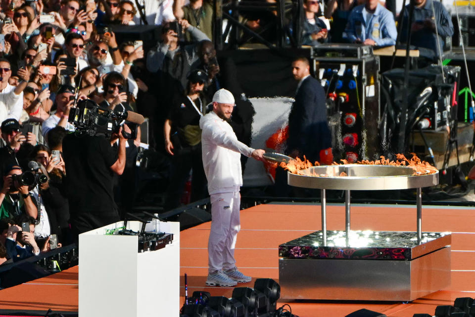 French rapper Julien Mari aka Jul lights the Olympic and Paralympic Torch Relays cauldron