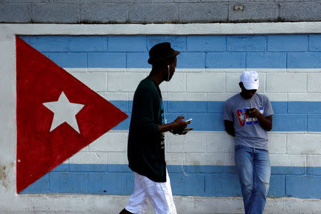 A teenager looks at his mobile phone as he connects to the internet in downtown Havana, following the announcement of the death of the Cuban revolutionary leader Castro, in Havana, Cuba November 27, 2016. REUTERS/Stringer