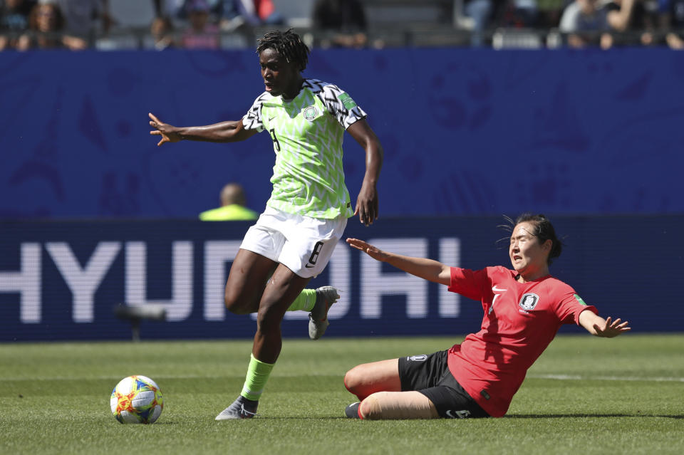 Nigeria's Asisat Oshoala gets away from South Korea's Hwang Bo-ram on her way to scoring her side's second goal during the Women's World Cup Group A soccer match between Nigeria and South Korea in Grenoble, France, Wednesday June 12, 2019.(AP Photo/Laurent Cipriani)