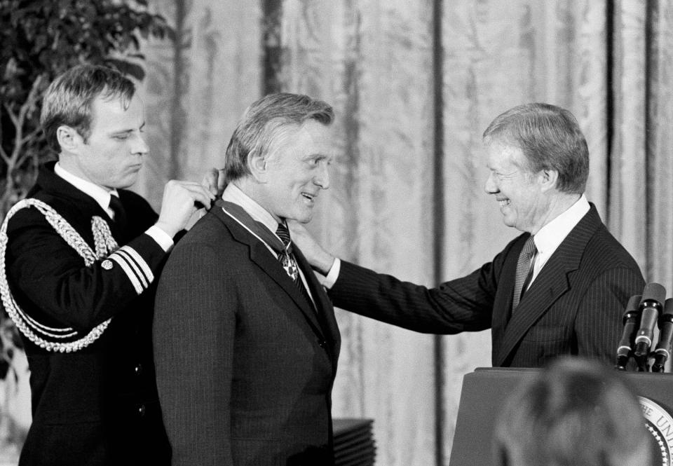 FILE - In this Jan. 16, 1981 file photo, President Jimmy Carter, right, congratulates actor Kirk Douglas upon receiving the Medal of Freedom, the nation's highest civilian honor, at the White House in Washington. Douglas died Wednesday, Feb. 5, 2020 at age 103. (AP Photo/Ira Schwarz, File)