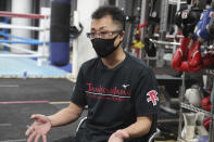 Shingo Inoue, father of Japanese boxer and the WBA and IBF bantamweight world champion Naoya Inoue, speaks during an interview with the Associated Press at the Ohashi Boxing Gym in Yokohama Monday, Nov. 23, 2021. Drawing praise as one of the best "pound for pound" active boxers around, and the best out of Asia since the legendary Manny Pacquiao, Inoue now has his eyes on the big money and American stardom. (AP Photo/Koji Sasahara)