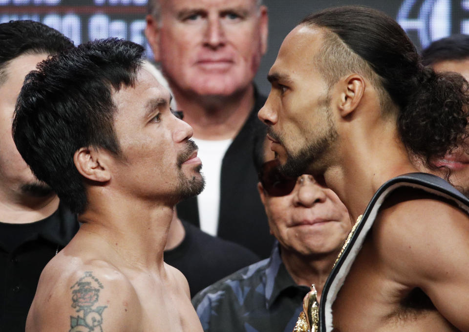 Manny Pacquiao, left, and Keith Thurman pose during a weigh-in Friday, July 19, 2019, in Las Vegas. The two are scheduled to fight in a welterweight championship boxing match Saturday in Las Vegas. (AP Photo/John Locher)