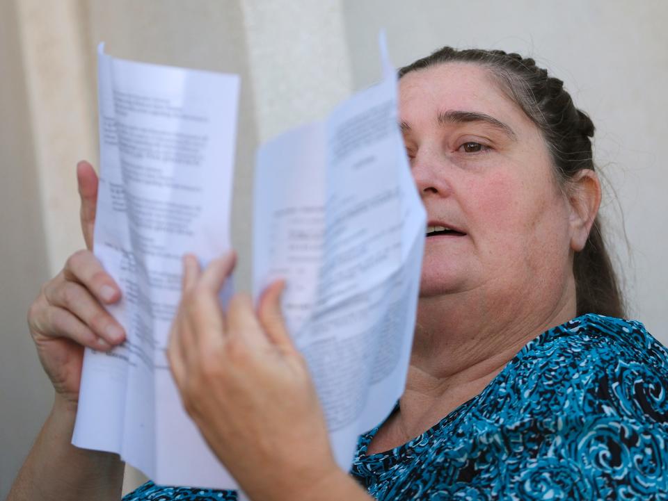Danni Legg looks at papers while in line to attend the Sept. 28 Oklahoma State Board of Education meeting.