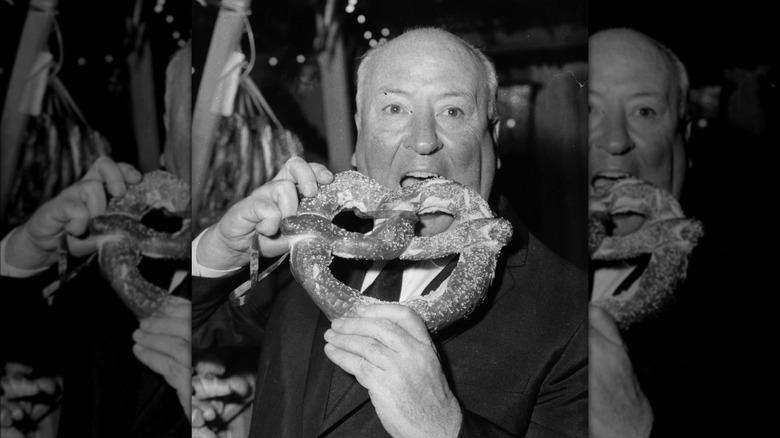 Alfred Hitchcock eating a pretzel