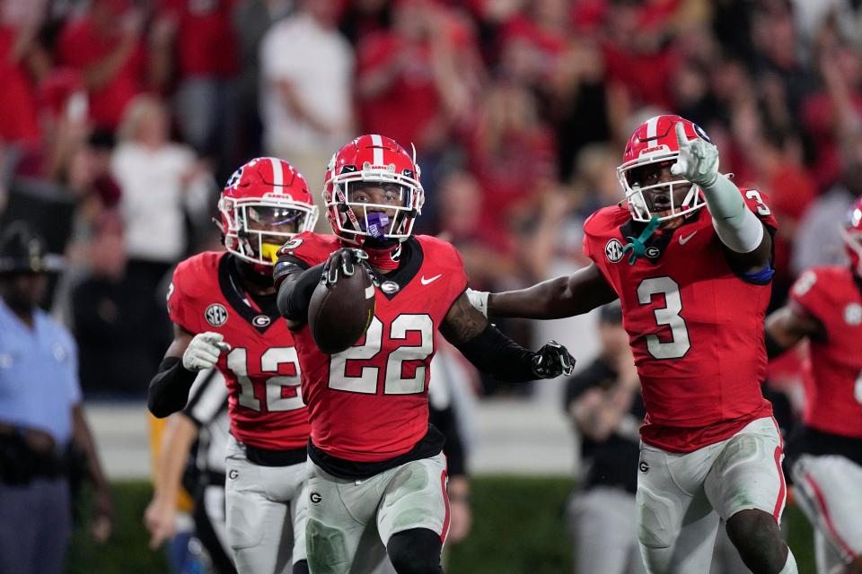 Georgia defensive back Javon Bullard (22) celebrates with Kamari Lassiter (3) and Julian Humphrey (12) after intercepting a pass during the second half against Missouri at Sanford Stadkum, Saturday, Nov. 4, 2023, in Athens, Ga.