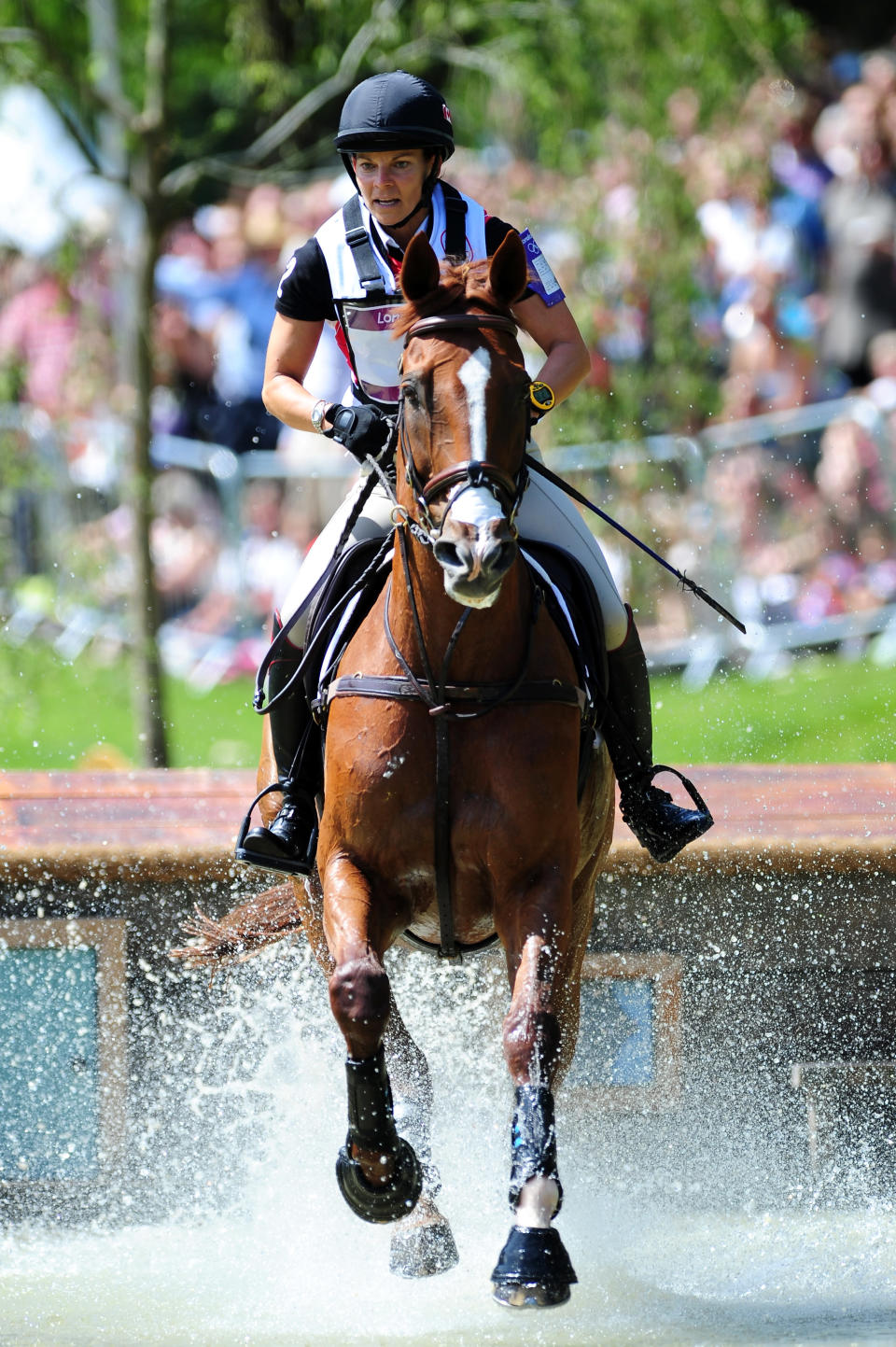 LONDON, ENGLAND - JULY 30: Michelle Mueller of Canada riding Amistad negotiates a jump in the Eventing Cross Country Equestrian event on Day 3 of the London 2012 Olympic Games at Greenwich Park on July 30, 2012 in London, England. (Photo by Mike Hewitt/Getty Images)