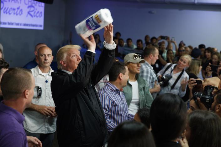 <p>President Donald Trump tosses paper towels into a crowd as he hands out supplies at Calvary Chapel, Tuesday, Oct. 3, 2017, in Guaynabo, Puerto Rico. Trump is in Puerto Rico to survey hurricane damage. (Photo: Evan Vucci/AP) </p>