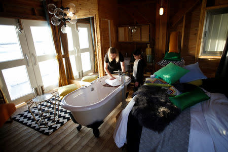 A woman checks the interior of a lifeguard tower, renovated into a luxury hotel suite, is seen a day before winners of an international online competition come to spend the night at the tower, at Frishman Beach in Tel Aviv, Israel March 13, 2017. Picture taken March 13, 2017. REUTERS/Baz Ratner