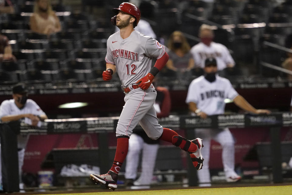 Cincinnati Reds' Tyler Naquin rounds the bas after hitting a solo home run against the Arizona Diamondbacks during the fourth inning of a baseball game, Friday, April 9, 2021, in Phoenix. (AP Photo/Matt York)