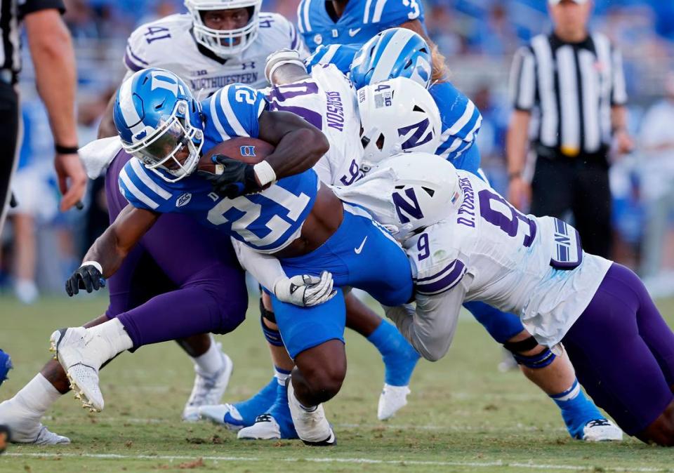 Duke’s Peyton Jones is brought down by Northwestern’s R.J. Pearson and Devin Turner during the second half of the Blue Devils’ 38-14 win on Saturday, Sept. 16, 2023, at Wallace Wade Stadium in Durham, N.C. Kaitlin McKeown/kmckeown@newsobserver.com