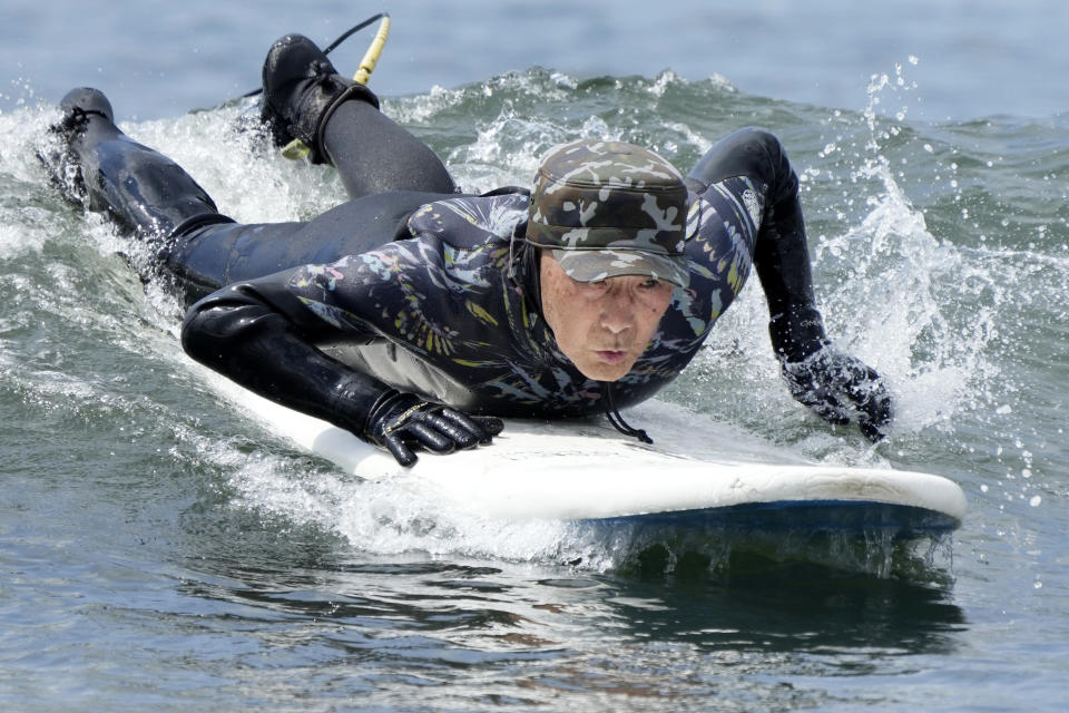 Seiichi Sano, an 89-year-old Japanese man, tries to ride a wave at Katase Nishihama Beach, Thursday, March 30, 2023, in Fujisawa, south of Tokyo. Sano, who turns 90 later this year, has been recognized by the Guinness World Records as the oldest male to surf. (AP Photo/Eugene Hoshiko)