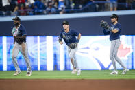 From left to right, Tampa Bay Rays' Randy Arozarena, Josh Lowe and Jonny DeLuca celebrate after they defeated the Toronto Blue Jays in a baseball game in Toronto, Friday, May 17, 2024. (Christopher Katsarov/The Canadian Press via AP)