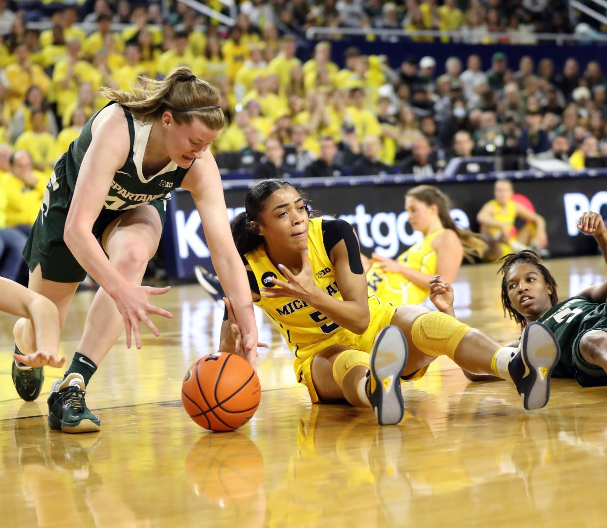 Michigan Wolverines guard Laila Phelia (5) goes for the ball against Michigan State Spartans guard Julia Ayrault (40) during second-quarter action at Crisler Center in Ann Arbor on Saturday, Jan. 14, 2023.