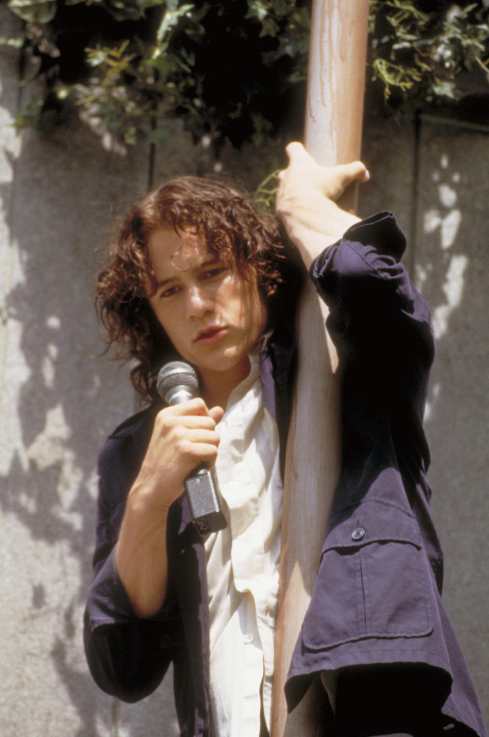 Heath Ledger hugging a pole