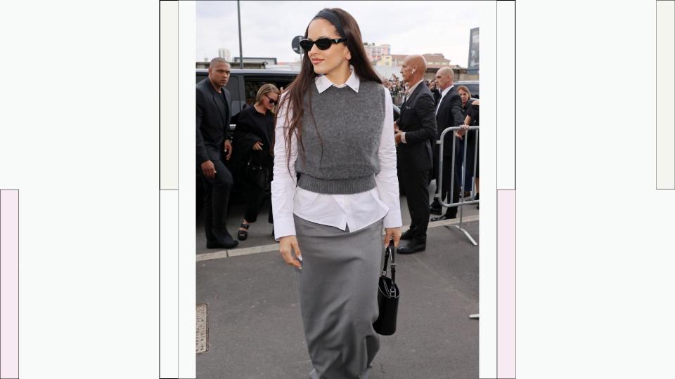 Rosalía wears a grey sweater vest, a white shirt and black sunglasses as she  attends the Prada fashion show during the Milan Fashion Week Womenswear Spring/Summer 2024 on September 21, 2023 in Milan, Italy.