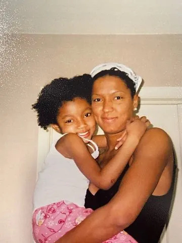 <p>Angel Reese X</p> Angel Reese with her mom Angel Webb Reese when she was a child.