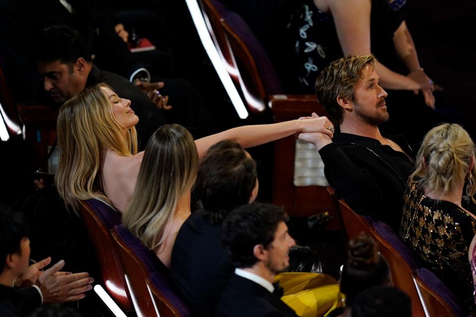 "Barbie" co-stars Ryan Gosling and Margot Robbie hold hands during the 96th Oscars at the Dolby Theatre at Ovation Hollywood in Los Angeles on March 10, 2024. Gosling is nominated for best supporting actor for his performance as Ken in "Barbie."