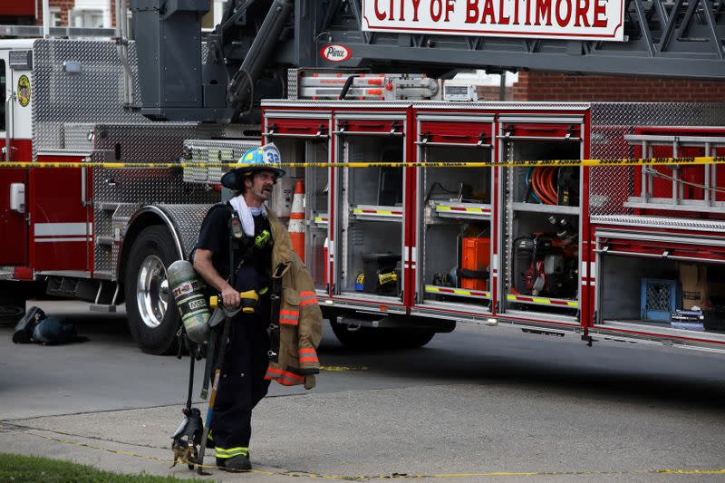 A firefighter is seen at the scene of an explosion in a residential area of Baltimore