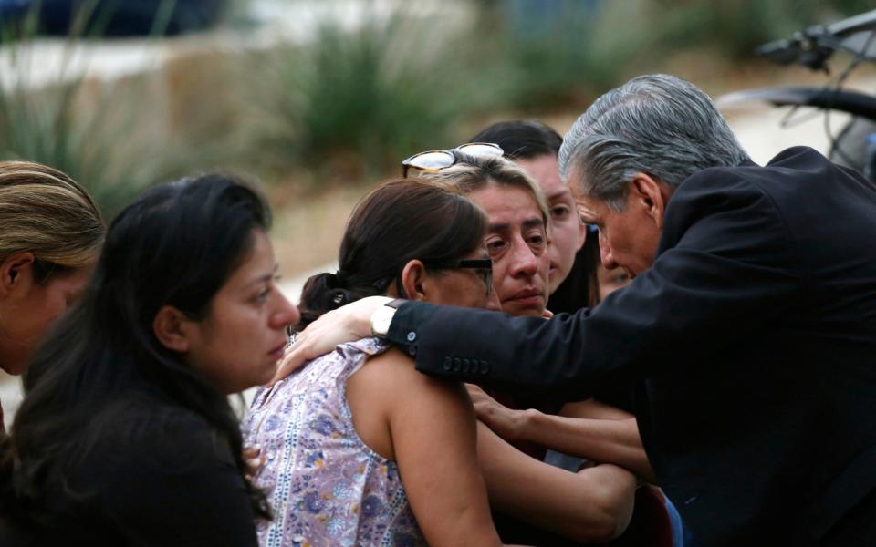 The Archbishop of San Antonio, right, consoles families in Uvalde - AP