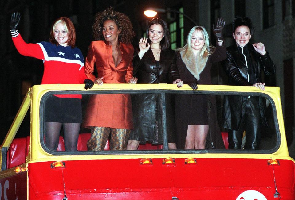 NEW YORK, UNITED STATES:  The Spice Girls' Ginger Spice (Geraldine Halliwell) (L) -- Scary Spice (Melanie Janine Brown) (2nd from L) -- Posh Spice (Victoria Beckham) (C) -- Baby Spice (Emma Lee Burton) (2nd from R) -- and Sporty Spice (Melanie Jayne Chisolm) (R)  --  arrive atop a double decker bus for a screening of their new movie 