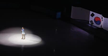 South Korea's Kim Yuna stands in the limelight in front of a lit Korean flag during the Figure Skating Gala Exhibition at the 2014 Sochi Winter Olympics February 22, 2014. REUTERS/David Gray