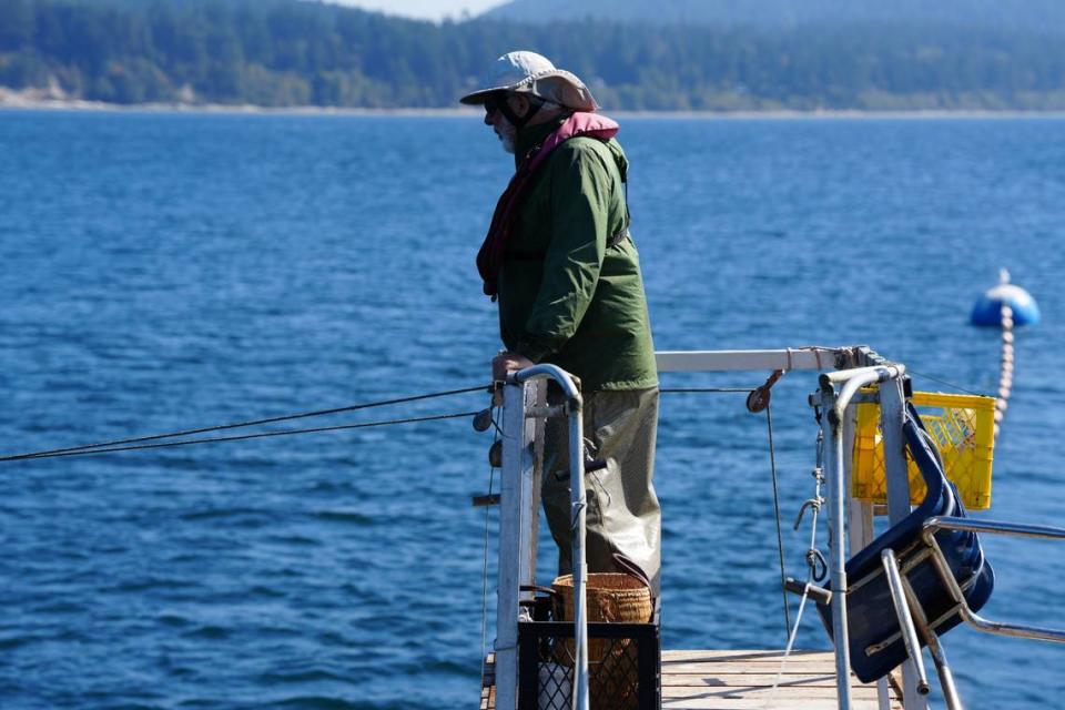 Riley Starks watches for salmon from a high tower on his reef net fishing boat off Lummi Island on Sept. 14, 2023.