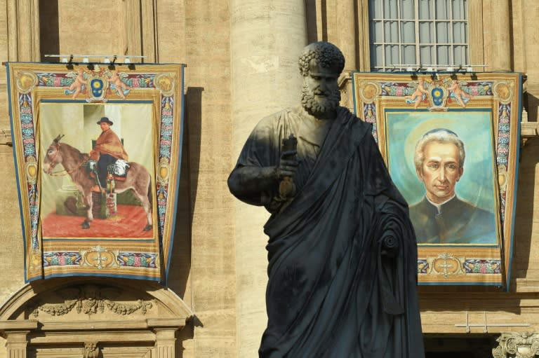 Tapestries on the facade of St Peter's basilica show portraits of Jose Gabriel Brochero (L) and Lodovico Pavoni (R) during a canonization mass led by Pope Francis on October 16, 2016 in the Vatican