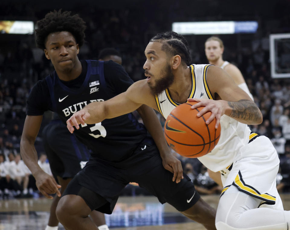 Providence guard Jared Bynum (4) drives against Butler guard Chuck Harris (3) during the first half of an NCAA college basketball game, Sunday, Jan. 23, 2022, in Providence, R.I. (AP Photo/Mary Schwalm)