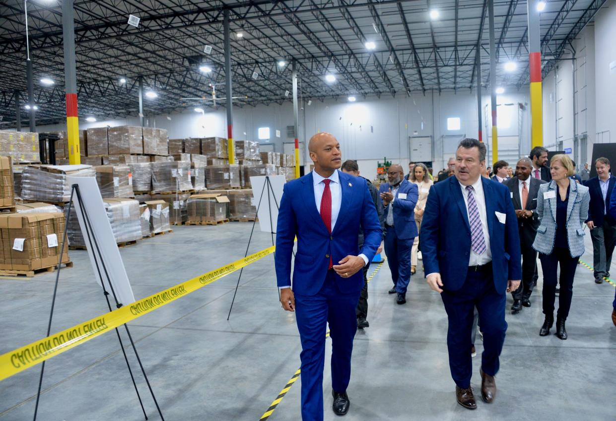 Maryland Gov. Wes Moore and Dan Kochenash, Conair's senior vice president of distribution, at the start of a tour Friday of Conair's new distribution center near Hagerstown. To the right in the gray blazer is Conair President and CEO Kristie Juster.