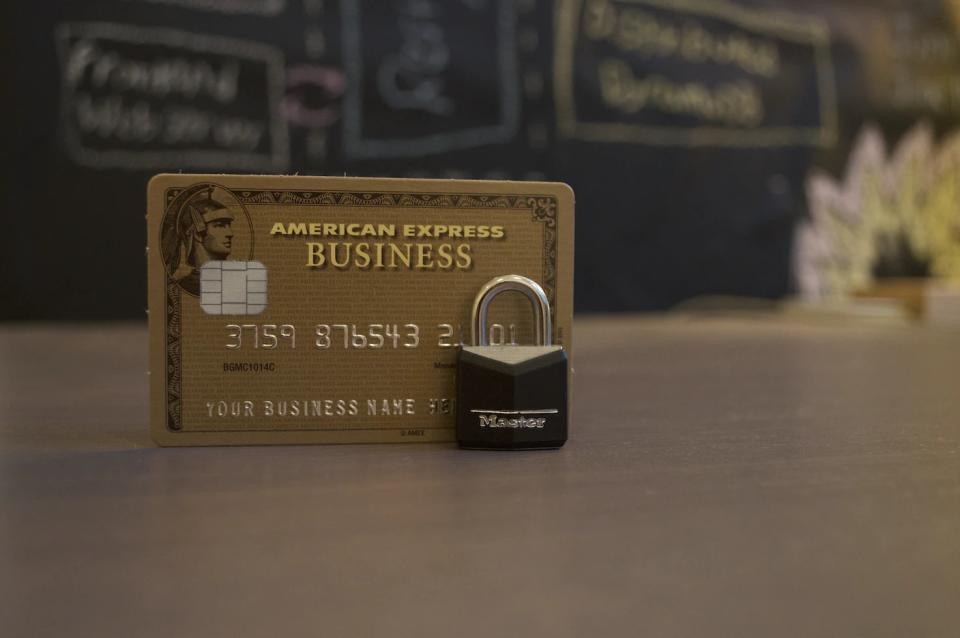 picture of an american express business card with a padlock in front of it