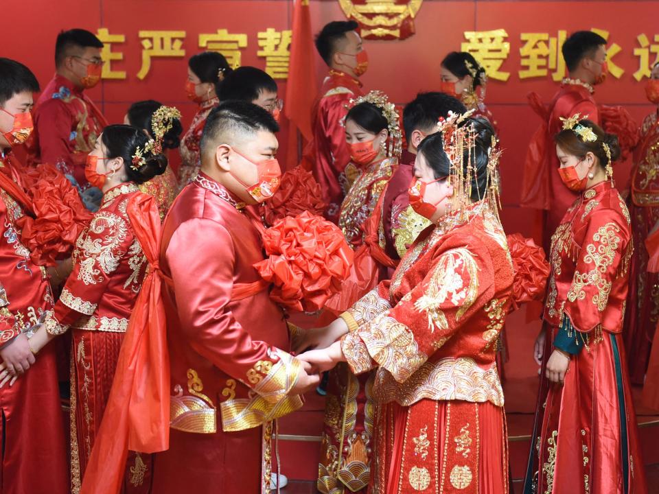 Couples attend a group wedding ceremony at a marriage registry in Donghai in China's eastern Jiangsu province on February 22, 2022, a palindrome day written as 