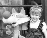 Amela Dizdar, 3, poses with a replica of the Winter Olympics mascot named Vucko in Sarajevo in 1984. The mascot was the creation of Joze Trobec, an academic painter from Kranj in Slovenia. (AP Photo/Bob Dear)