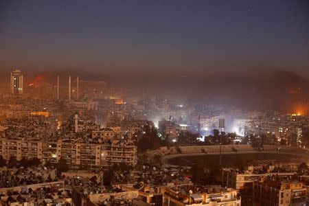 Smoke and flames rise after air strikes on rebel-controlled besieged area of Aleppo, as seen from a government-held side, in Syria December 11, 2016. REUTERS/Omar Sanadiki