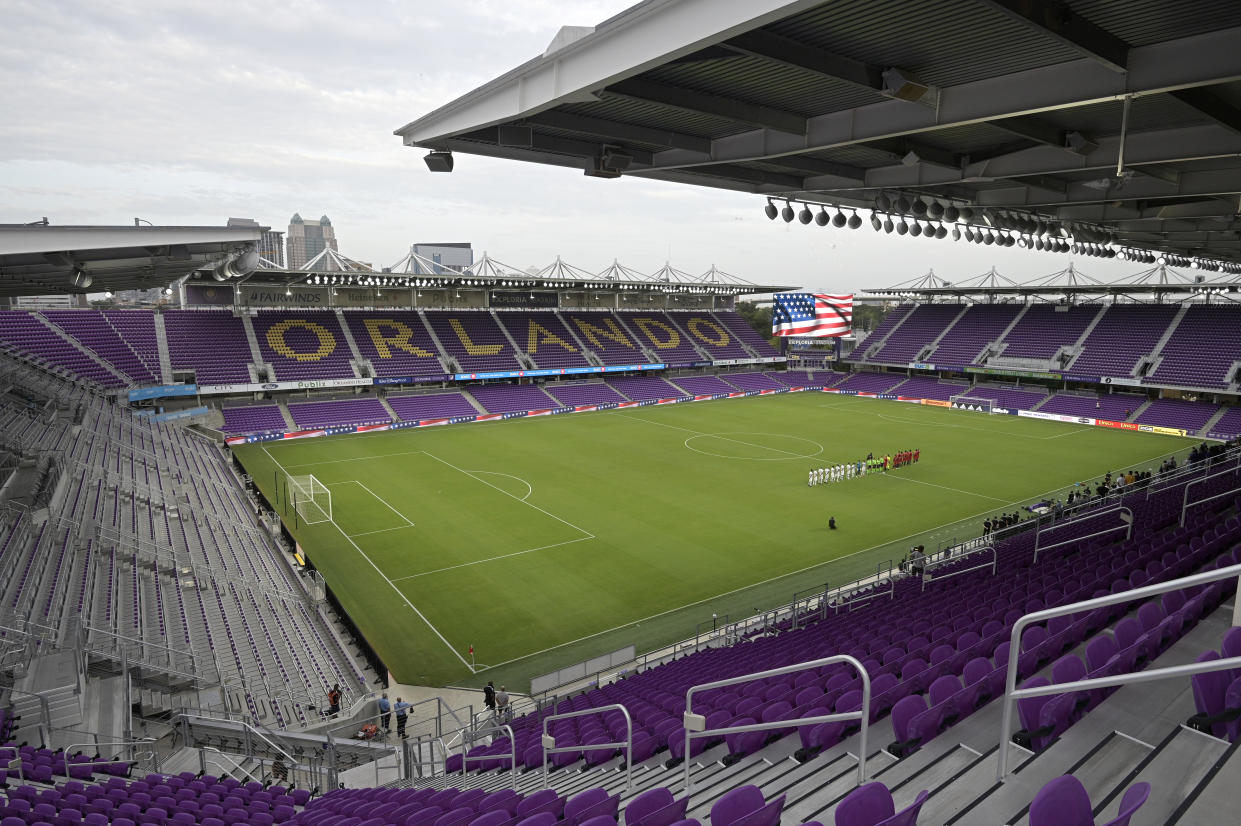 FILE - Players with Toronto FC, right, and Orlando City stand on the pitch at Exploria Stadium before an MLS soccer match, Saturday, June 19, 2021, in Orlando, Fla. The United States will play its final home World Cup qualifier at Orlando, Florida, on March 27 against Panama. The U.S. Soccer Federation announced Wednesday, Jan. 19, 2022,  that the match will be at Exploria Stadium, where the Americans beat Panama 4-0 on Oct. 6, 2017, also their next-to-last qualifier. (AP Photo/Phelan M. Ebenhack)