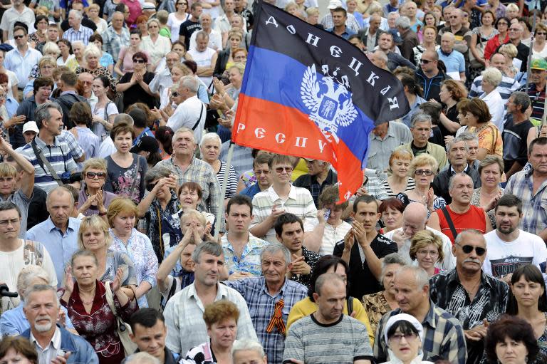 A demonstrator waves the flag of the self-proclaimed People's Republic of Donetsk during a rally of pro-Russia supporters in Lenin Square in the eastern Ukrainian city of Donetsk, on July 6, 2014