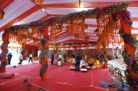 Hindu priests prepare the site for a groundbreaking ceremony of a temple dedicated to the Hindu god Ram in Ayodhya, India, Wednesday, Aug. 5, 2020. The coronavirus is restricting a large crowd, but Hindus were joyful before Prime Minister Narendra Modi breaks ground Wednesday on a long-awaited temple of their most revered god Ram at the site of a demolished 16th century mosque in northern India. (AP Photo/Rajesh Kumar Singh)