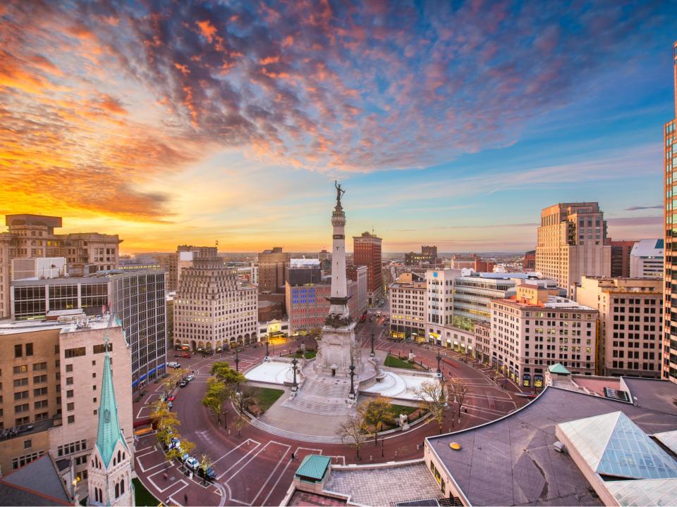 Indianapolis skyline over Soliders' and Sailors' Monument at dusk.