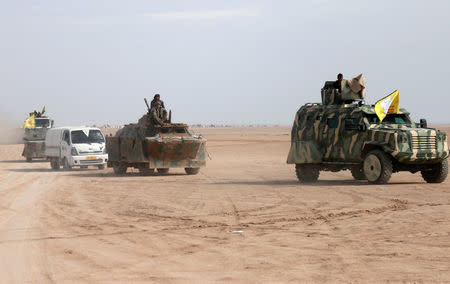 FILE PHOTO: Syrian Democratic Forces (SDF) fighters ride on vehicles in the north of Raqqa city, Syria February 5, 2017. REUTERS/Rodi Said/File Photo