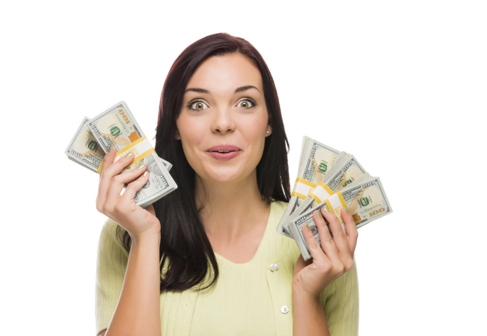 Happy woman with cash in both hands.