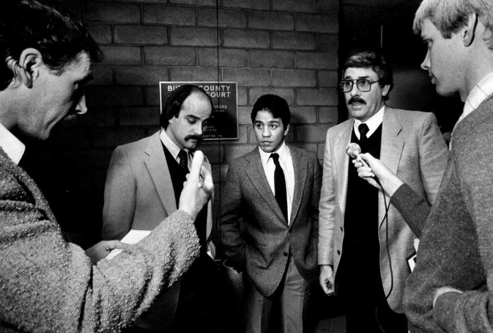 Sacramento attorney John Virga speaks to reporters inside Oroville Justice Court in November 1984 as his client, boxer Bobby Chacon, looks on. Virga, who represented a number of boxers and other professional athletes, died July 14, 2023.