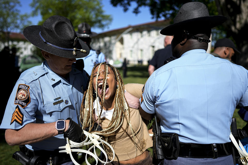 Georgia State Patrol officers detain a demonstrator on the campus of Emory University during a pro-Palestinian demonstration, Thursday, April 25, 2024, in Atlanta. (AP Photo/Mike Stewart)